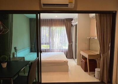 Modern bedroom with glass sliding door and wooden desk