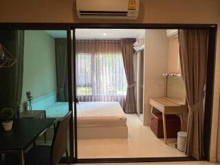 Modern bedroom with glass sliding door and wooden desk