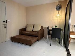 Cozy living room with a brown sofa and dining area