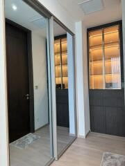 Modern hallway with glass shelves and mirrored closet doors