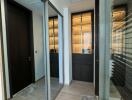 Modern hallway with mirrored closets and recessed lighting