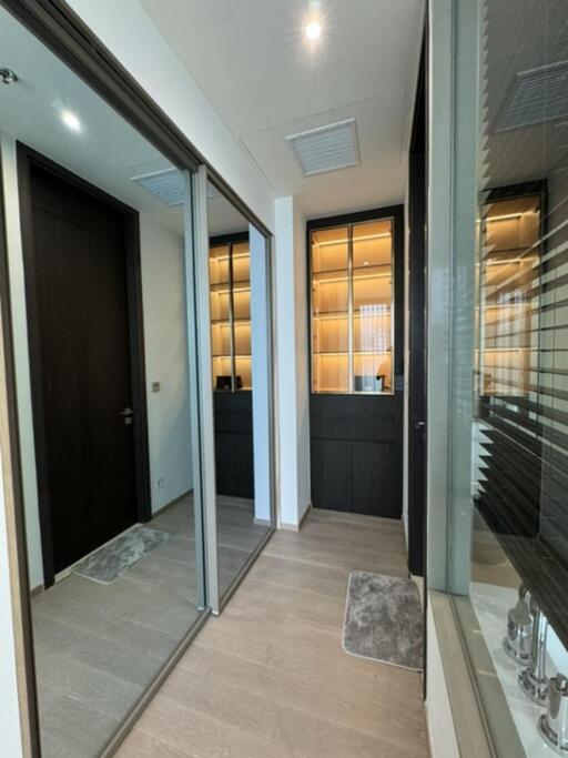 Modern hallway with mirrored closets and recessed lighting