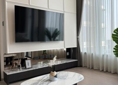 Modern living room with a wall-mounted TV and stylish decor