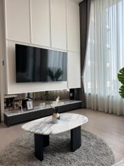 Modern living room with a wall-mounted TV and stylish decor