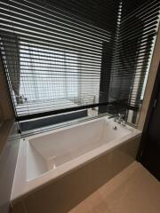 Modern bathroom with bathtub and blinds