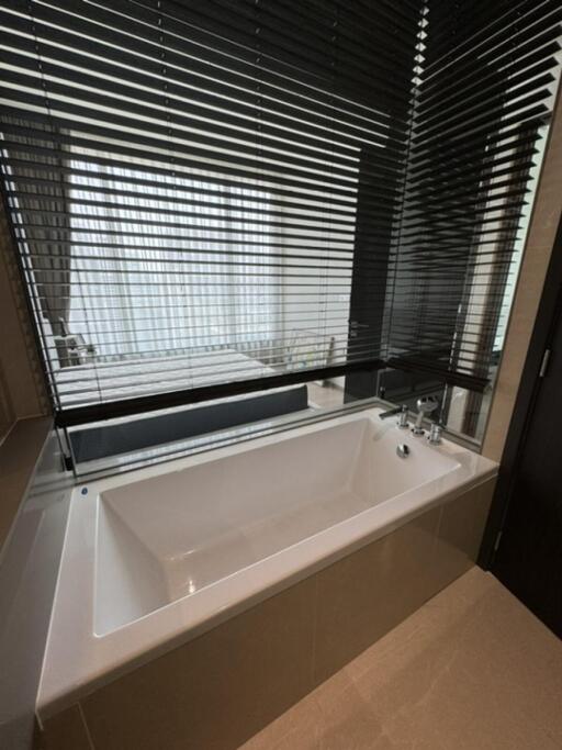 Modern bathroom with bathtub and blinds