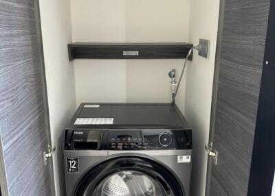 Compact laundry area with washer and shelf