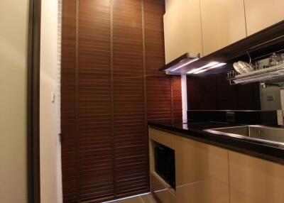 Modern kitchen with wooden blinds and built-in appliances