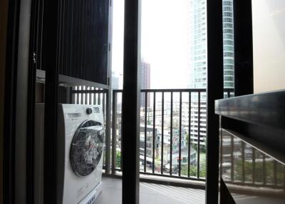 Balcony with washing machine and city view