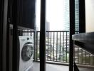 Balcony with washing machine and city view