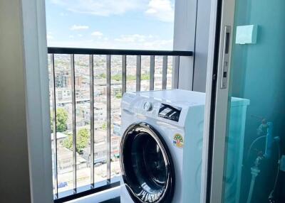 Laundry area with a washing machine and city view