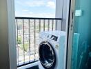 Laundry area with a washing machine and city view