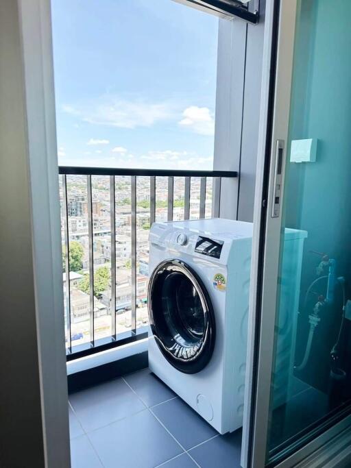 Laundry area with a washing machine and city view