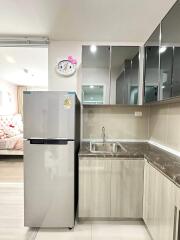 Modern kitchen with nearby bedroom