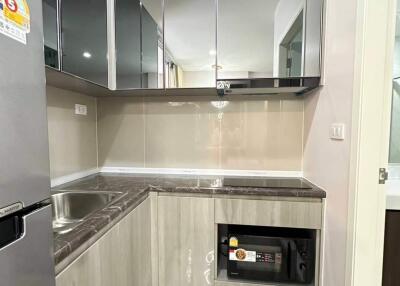 Modern kitchen with stainless steel appliances and reflective cabinetry