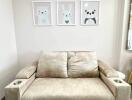 Beige sofa with cup holders and cute animal wall art