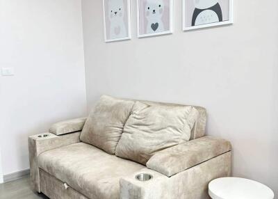 Cozy living room with a plush sofa and cute animal artwork