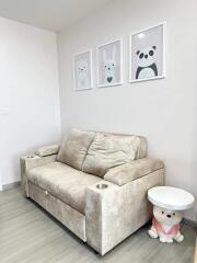 Cozy living room with a plush sofa and cute animal artwork