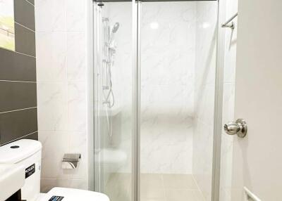 Modern bathroom with a glass shower enclosure and tiled walls