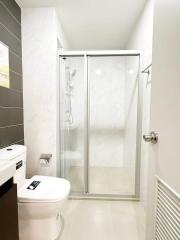 Modern bathroom with a glass shower enclosure and tiled walls