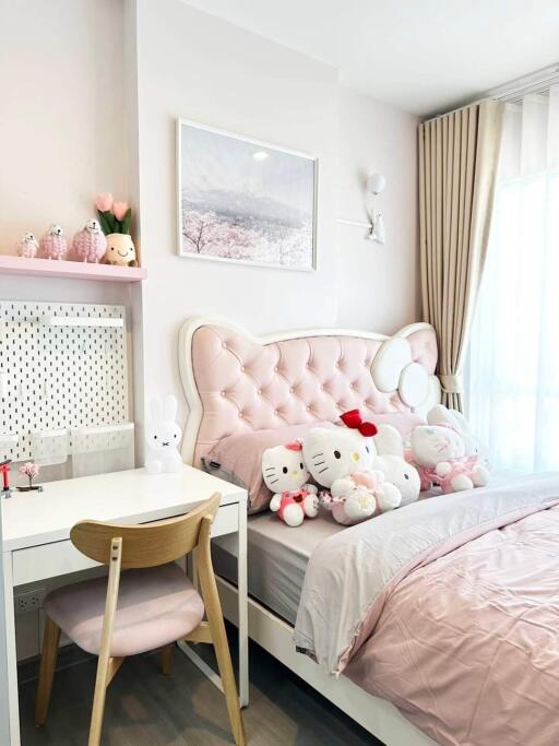 Bedroom with pink decor and plush toys