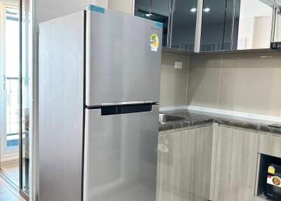 Modern kitchen with stainless steel refrigerator and mirrored cabinets