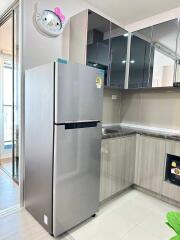 Modern kitchen with stainless steel refrigerator and mirrored cabinets