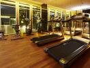 Modern gym with large windows and various fitness equipment