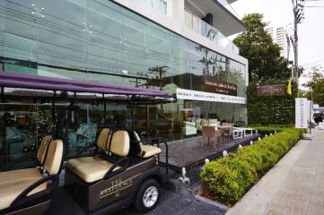 Exterior view of a modern building with a golf cart parked in front