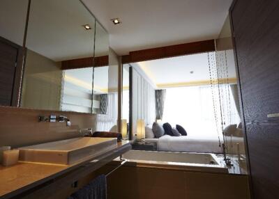 Modern bathroom with a view of the bedroom