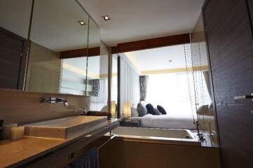 Modern bathroom with a view of the bedroom