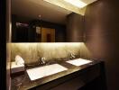 Modern bathroom with double sinks and ambient lighting