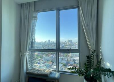 Living room with large window and city view