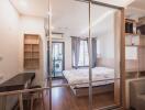 Bedroom with sliding glass doors, bed, desk, and shelving unit