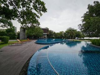 Serene outdoor pool area with lounging chairs