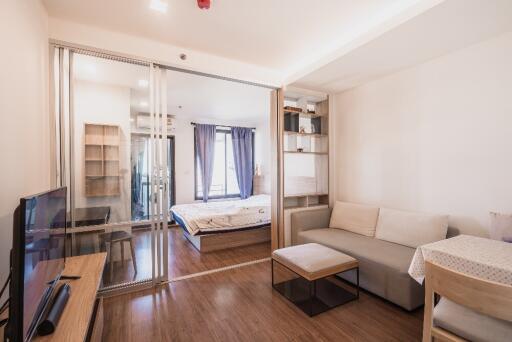 Modern living room with a view into the bedroom