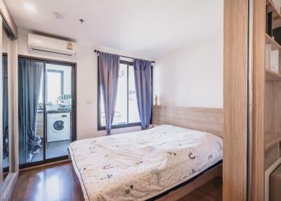 Modern bedroom with large window and balcony access