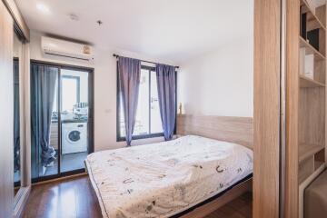 Modern bedroom with large window and balcony access