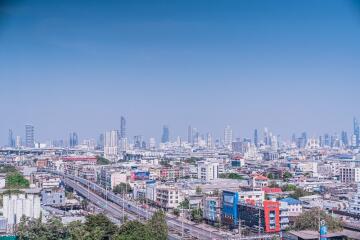 Aerial view of city skyline with multiple buildings and clear blue sky