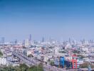 Aerial view of city skyline with multiple buildings and clear blue sky