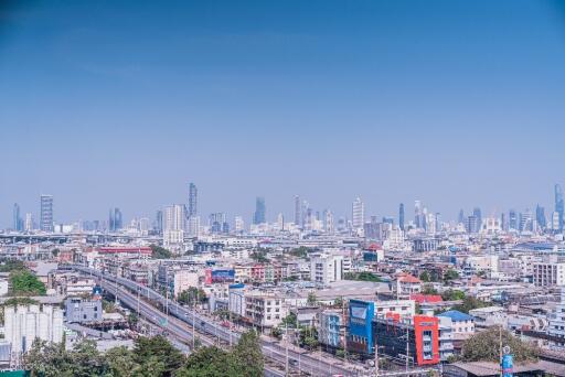 Aerial view of city skyline with multiple buildings and clear blue sky