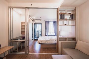 Well-lit bedroom with sliding glass doors and built-in shelves