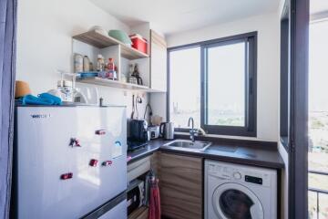 Small modern kitchen with appliances and a window