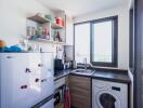 Small modern kitchen with appliances and a window