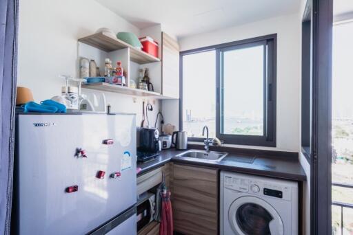 Small modern kitchen with appliances and a window