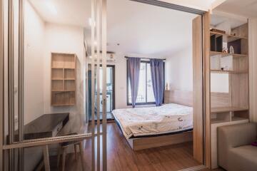 Modern bedroom with wooden flooring and furniture