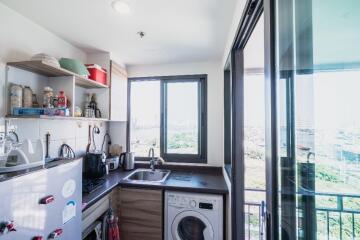 Bright modern kitchen with appliances and balcony view