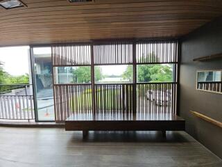 Bench with a view of the outdoors through large wooden slats