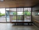 Bench with a view of the outdoors through large wooden slats