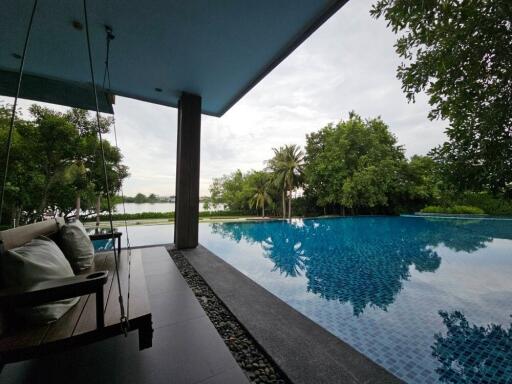 Outdoor view of a luxurious poolside with swing seating